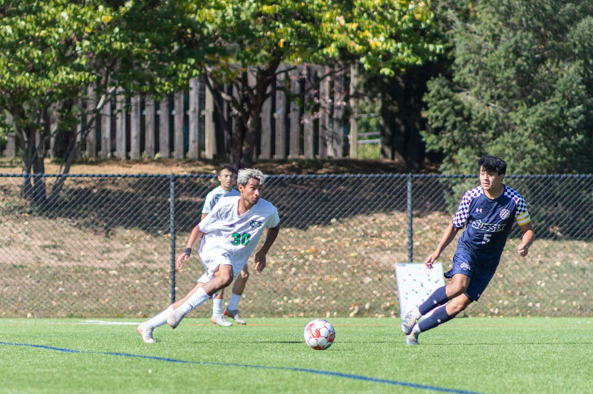 High school players competing during a soccer match